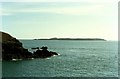 SM7509 : Rock headland off Wooltack Point, Skomer Island on horizon by Tom Pennington