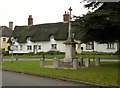 TM0481 : War Memorial and thatched cottages at South Lopham by Robert Edwards