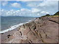 NS1557 : Shoreline rocks at Fintray Bay by Richard Law