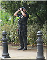 TQ2777 : Diamond Jubilee Pageant - armed policeman scans rooftops with binoculars by David Hawgood