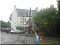 NT9851 : Cars and signs in front of East Ord Village Store by Graham Robson