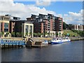 NZ2564 : Flow tidemill artwork and river cruise boats moored on the Tyne by Graham Robson