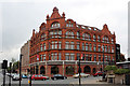 SD7109 : Co-operative symbols and slogan on the former drapery store, in red terracotta by Alan Murray-Rust