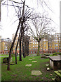 TQ3082 : Trees and ledger stones, St Andrew's Gardens by Stephen Craven