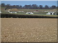 TF8732 : Grass covered bunkers at Sculthorpe Airfield by Richard Humphrey