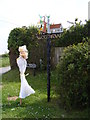 TM2993 : Woodton Village sign & Scarecrow by Geographer