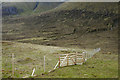 NH0749 : Deer fence on slope of Meall an Fhliuchaird by Trevor Littlewood