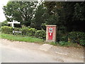 TM2788 : Roadsigns & The Old Post Office George V Postbox by Geographer