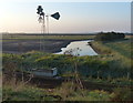 TF6228 : Wind pump and drain on the edge of Wootton Marsh by Mat Fascione