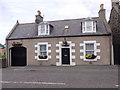 NJ5965 : A cottage on the A98 through Portsoy by Stanley Howe