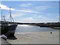 L8808 : Kilronan Harbour. Boat and children by Martin Kerans