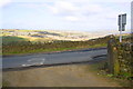 SE0537 : Farm track emerging onto Bingley Road by Roger Templeman