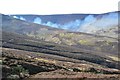 NT2632 : Heather moorland and muirburn smoke, Birkscairn Hill by Jim Barton