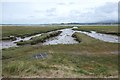 SH4459 : Creek created by drainage, Y Foryd by Christine Johnstone