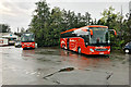 NT0805 : Two Orange Coaches outside Moffat Woollen Mill by David Dixon