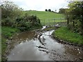 NY5145 : Muddy field entrance of the Longdales track by Christine Johnstone