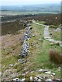 NZ0498 : Ancient wall and modern path by Russel Wills