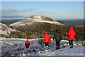 NT5431 : Walkers leaving the summit area of Eildon Wester Hill by Walter Baxter