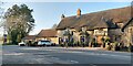 SU0968 : The A4 passes the Waggon and Horses, Beckhampton by HelenK