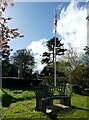 SP9410 : Wigginton - St Bartholomew - Bench and flagpole by Rob Farrow