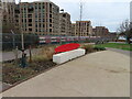 TQ2189 : Bench in Colindale Park, tube train beyond by David Hawgood