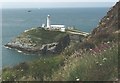 SH2082 : A Griffin from SARTU at RAF Valley flies past the South Stack lighthouse by Eric Jones