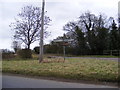 TM3765 : Roadsign & Island opposite Trust Farm by Geographer