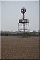 SP1403 : Windpump in a stubble field by Philip Halling