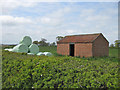 SE7479 : Red brick barn with bales by Pauline E