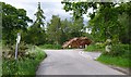 NH5542 : Timber stacked next to the road, by Upper Reelig by Craig Wallace