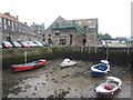 NT9952 : Small boats in front of the Chandlery by Graham Robson