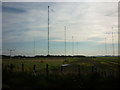 NY1758 : Radio masts and disused airfield by Ian S