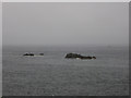 NT9464 : Hurker rock at close to high tide, Eyemouth harbour by Graham Robson