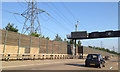 TQ0561 : Timber and glass noise barrier, M25 northwest of Byfleet by Robin Stott