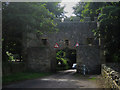 NU2519 : Gateway in road near Craster Tower by Graham Robson