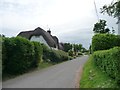 SU1156 : Large thatched house, Charlton St Peter by Christine Johnstone