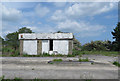 NZ3928 : Derelict petrol station on the A689 by Pauline E