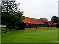 TQ5398 : Barns at Rose Hall Farm by Bikeboy