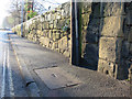 SJ3350 : Stone wall and a bench mark alongside Chester Road by John S Turner