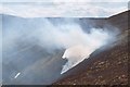 NT0631 : Smoke and snow, Birnies Bowrock by Jim Barton