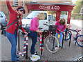 SP9211 : Yarn bombing the bicycle rails in Tring Church Square by Chris Reynolds