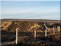 NZ0042 : Fence between two quarries by Trevor Littlewood