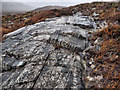 NN2063 : Rock Outcrop with Seams of Quartzite by Mick Garratt