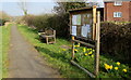 SO4830 : Parish noticeboard, bench and daffodils, Much Dewchurch by Jaggery