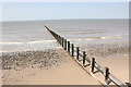 SJ0382 : Groyne and beach near Ffrith by Jeff Buck