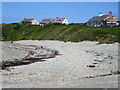 SH2987 : Shingle and bungalows at Porth Trwyn by John H Darch