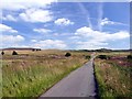 SK0165 : Minor road under a summer sky by Graham Hogg