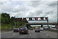 TQ0187 : Gantry and A40 bridge over M25 by David Smith