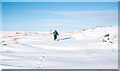 NZ0042 : Tracks on snow-covered hill road by Trevor Littlewood