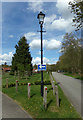 TM2241 : Lamppost & roadsign at Seven Hills Crematorium by Geographer